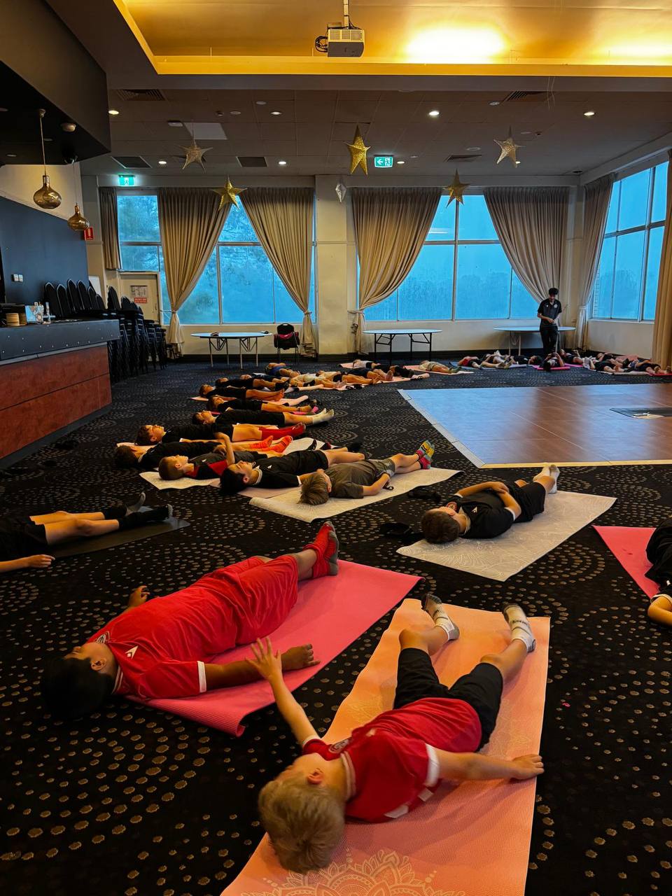 Athletes relaxing during a Yogi Club yoga session